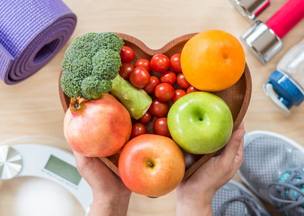 Heart shaped bowl with fruit and vegetables.